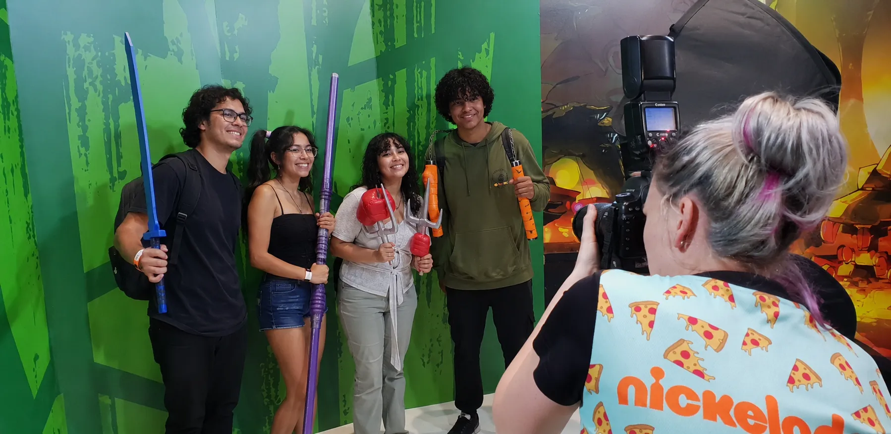 Photographer Capturing Fans Posing with TMNT Character Props